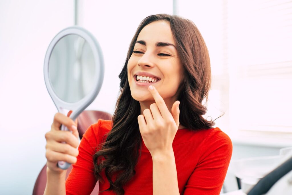 Patient admiring teeth results from cosmetic dentistry in Huntsville, AL