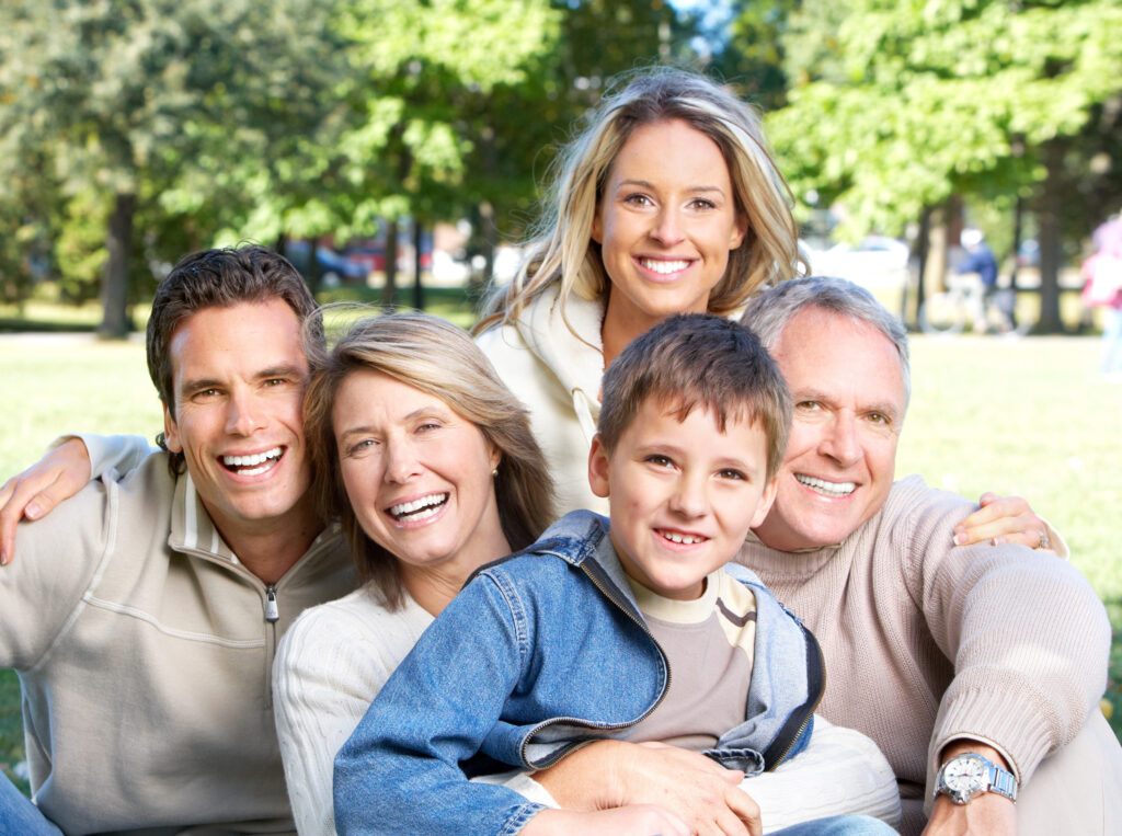 Family of all ages smiling, representing comprehensive dental care for children and adults
