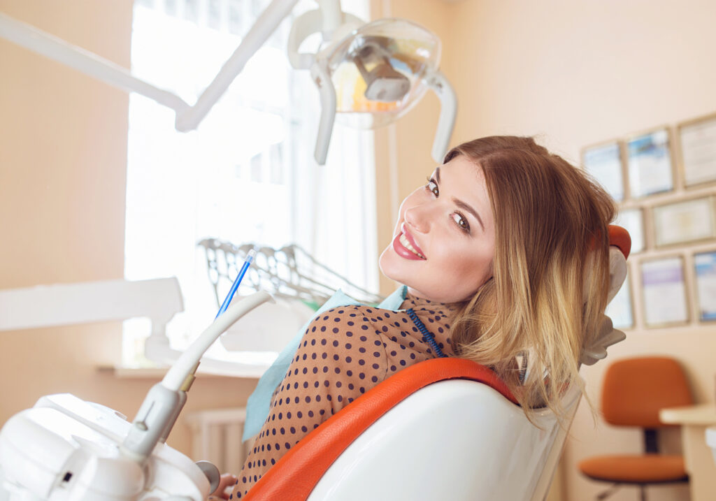 Woman sitting in dental chair receiving gum disease evaluation at Noel Dental Arts in Huntsville, AL